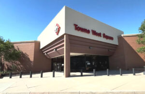 Modern shopping mall exterior at Tower West Square with brick facade and wide entrance.