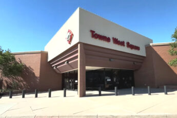 Modern shopping mall exterior at Tower West Square with brick facade and wide entrance.