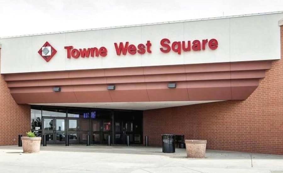 Behind the doors of Towne West Square Mall in Wichita, KS: decline, chaos, rebuild 9 Modern shopping center entrance with red signage and brick façade.