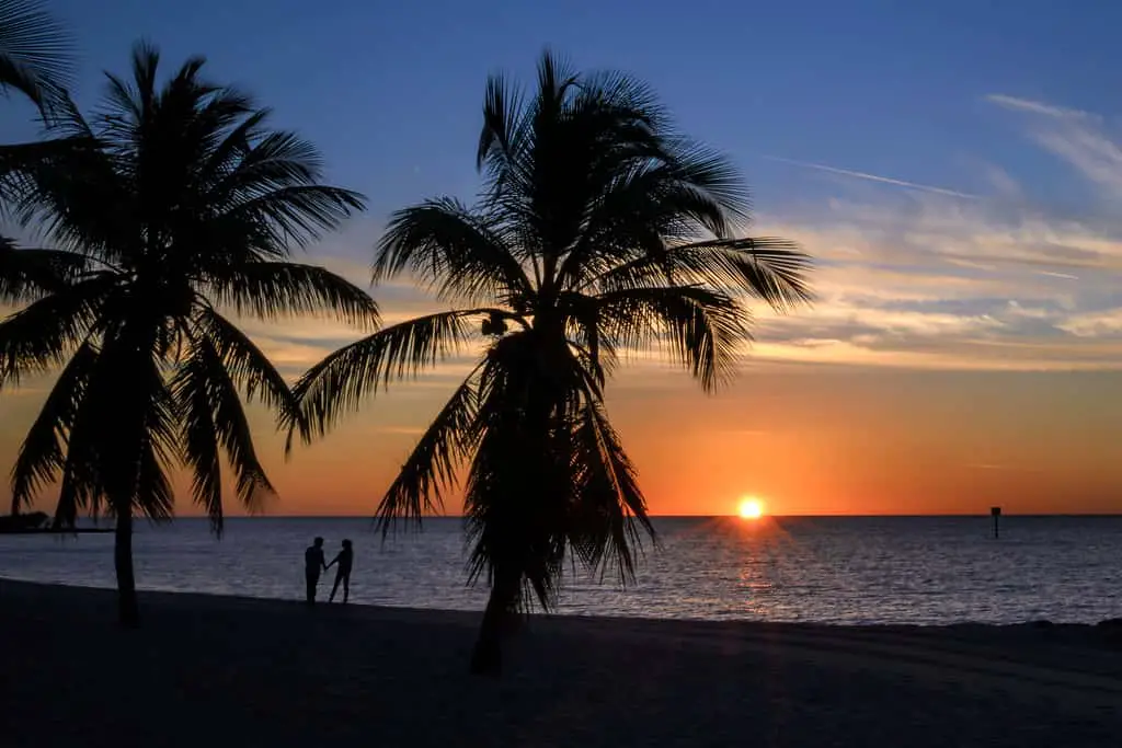 Couple in silhouette at sunrise on Smathers Beach, Key West, Florida